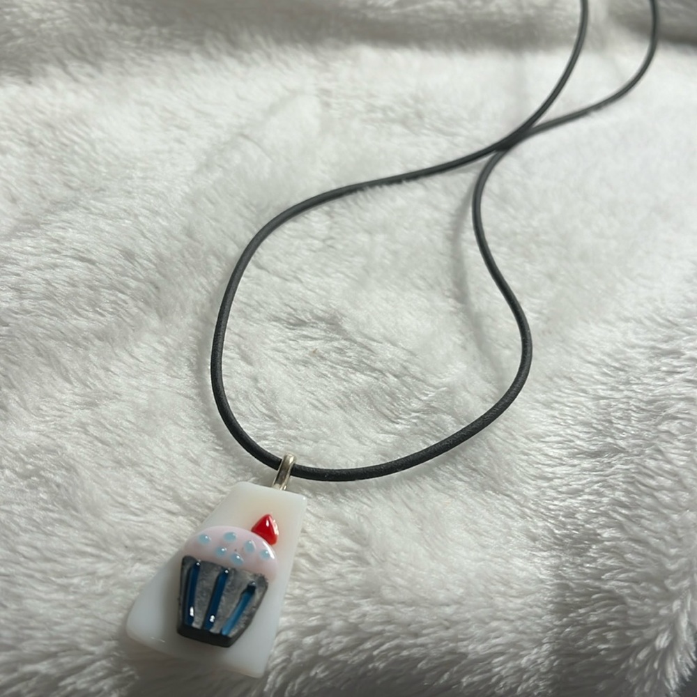 Necklace, children’s cupcake. black cord. pink icing, blue dots  and Cherrie